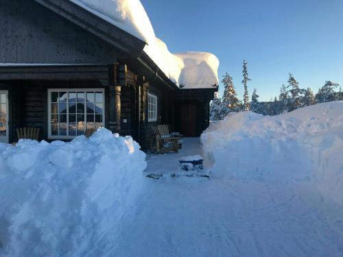 a pile of snow on the side of a house at Family Cabin At Blefjell in Lampeland