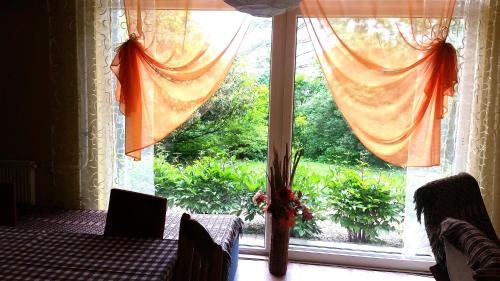 a room with a large window with a table and chairs at Areal Hradišek in Klobouky u Brna