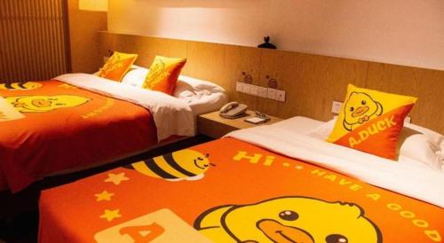 a hotel room with two beds with hello kitty pillows at Xian Elegant Oriental Hotel in Xi'an