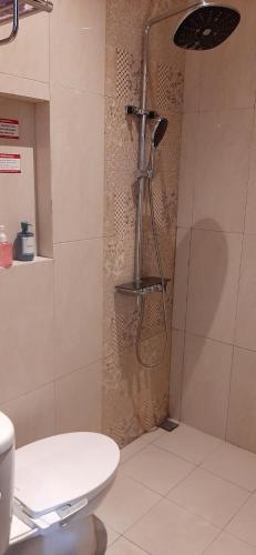 a shower in a bathroom with a toilet at Griya Endika Syariah in Yogyakarta