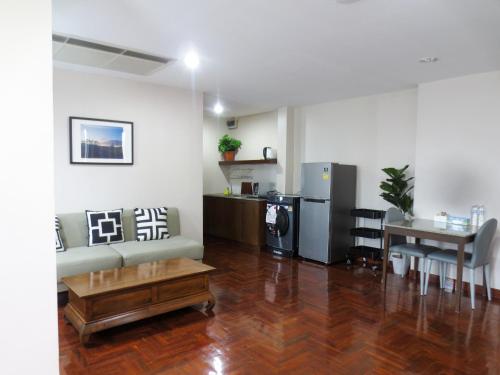 a living room with a couch and a table at P.K. Garden Home in Bangkok