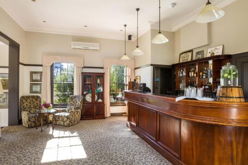 a barber shop with a wooden counter at Peppers Manor House in Sutton Forest