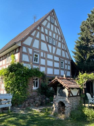 a house with a stone oven in front of it at Bergfohlenhof in Höchst im Odenwald