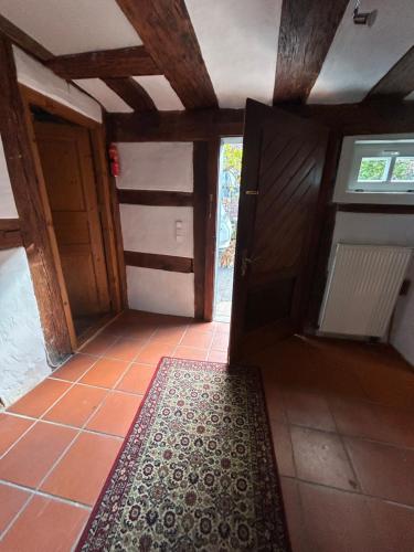 an empty room with a door and a rug on the floor at Bergfohlenhof in Höchst im Odenwald