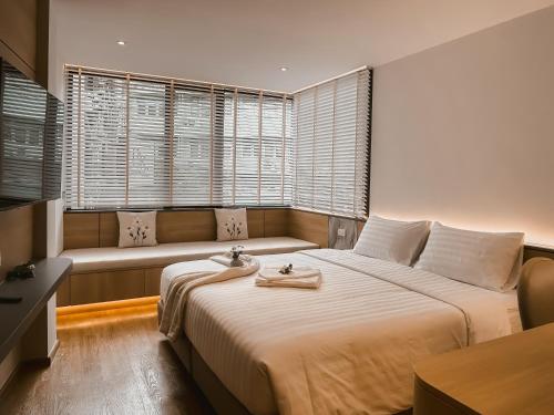 a bedroom with a large bed and a couch at P.K. Garden Home in Bangkok