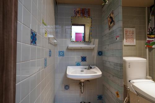 a bathroom with a sink and a toilet at Hotel HERMIT in Takamatsu