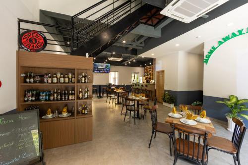 a restaurant with tables and chairs and a bar at Jana Hotel & Apartment - Firework & Aquatopia Water Park in Phu Quoc