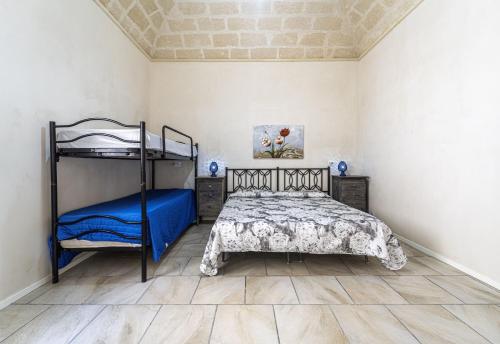 a bedroom with a bed and a bunk bed at La Casa del Paese in Favignana