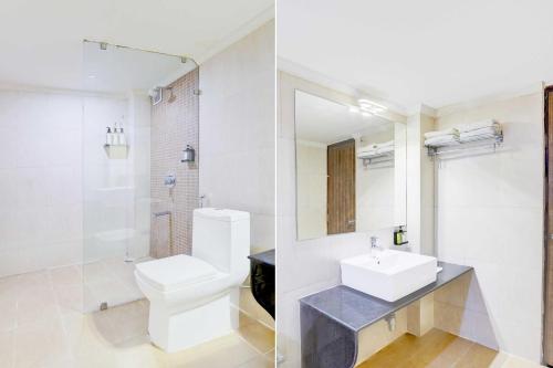 a bathroom with a white toilet and a sink at Palette Hotel Nisarga by Sunday Bhopal in Bhopal
