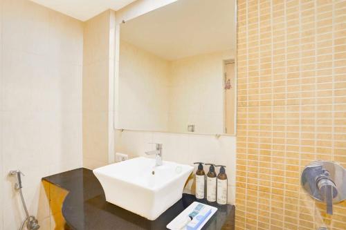 a bathroom with a white sink and a mirror at Palette Hotel Nisarga by Sunday Bhopal in Bhopal