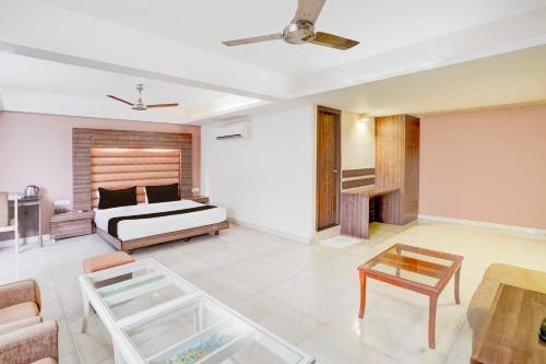 a bedroom with a bed and a coffee table at Palette Hotel Nisarga by Sunday Bhopal in Bhopal
