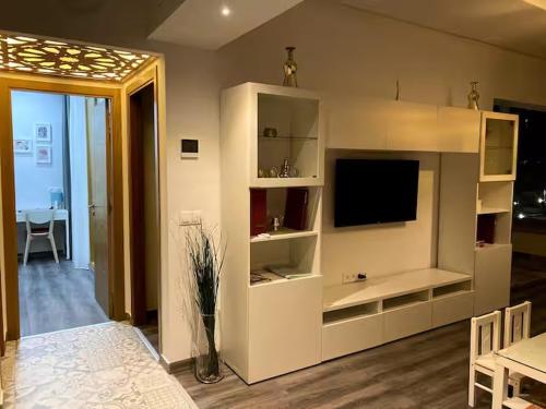 a living room with a white entertainment center with a television at Cabo Beach Home 1 in Cabo Negro