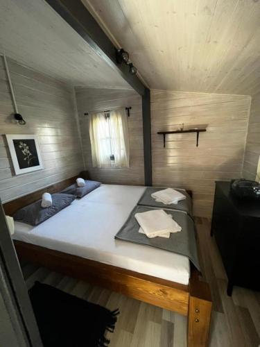 a bedroom with a large bed in a house at Chatka Daisy A,B in Pakoštane