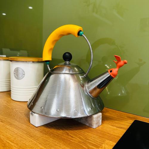 a tea kettle with a banana on top of a table at Aldgate Creek Cottage in Aldgate