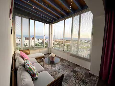 a living room with a couch and a large window at Cabo Beach Home 1 in Cabo Negro