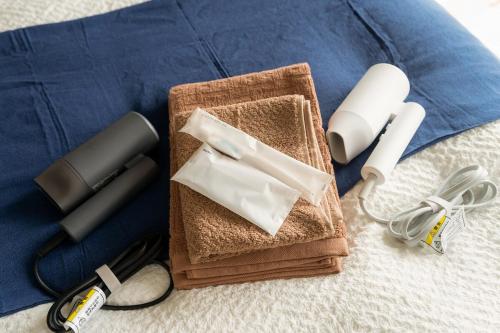 a table with a wii remote and other electronic items at Peace Branch in Yonabaru