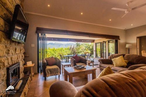 a living room with a couch and a fireplace at Aleah, Cathkin Estates by Euphoric Leisure in Champagne Valley