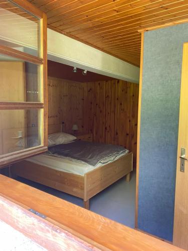 a room with a bed in a wooden cabin at gite duparcq lavigne in Steige
