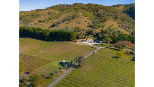 an aerial view of a house on a hill at Rae at Lake George Winery by Tiny Away in Collector