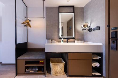a bathroom with a sink and a mirror at Atour Hotel Nanchang Jingkai District University of Finance and Economics in Nanchang