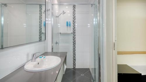 a bathroom with a sink and a shower at Best Western Cattle City Motor Inn in Rockhampton