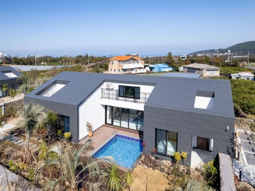 an aerial view of a house with a swimming pool at Gobajinin Private Pool Villa in Jeju