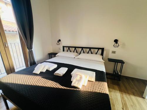 a bedroom with a large bed with towels on it at Vico Maria in Fondi