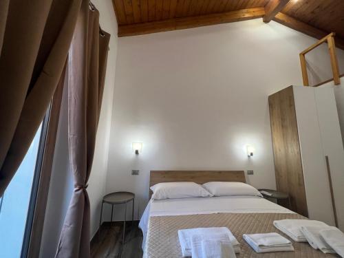a bedroom with a bed with two towels on it at Vico Maria in Fondi