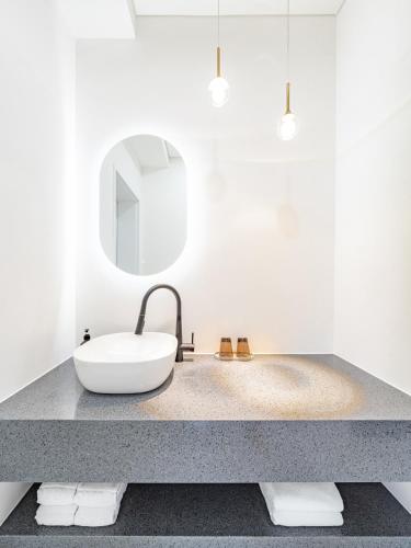 a bathroom with a sink and a mirror at Gobajinin Private Pool Villa in Jeju