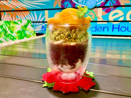 a glass jar filled with food on a table at Ma-Blue Garden House in Motobu