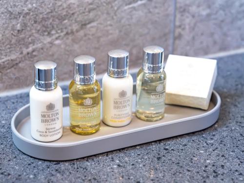 four bottles of essential oils sitting on a tray at Gobajinin Private Pool Villa in Jeju