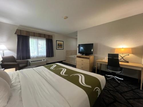 a hotel room with a bed and a desk at Quality Inn & Suites Loveland in Loveland