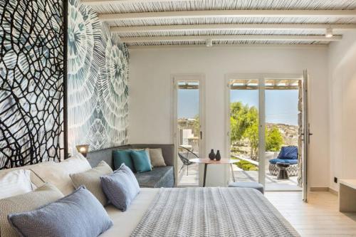 a bedroom with a bed and a living room at Amyth of Mykonos Super Paradise in Super Paradise Beach