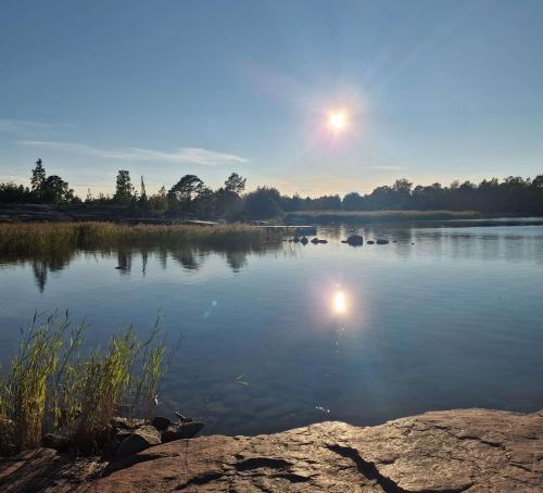 a view of a lake with the moon in the sky at Eckerö Camping & Stugor in Eckerö