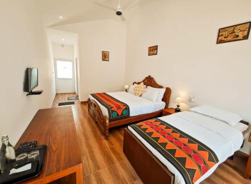 Un ou plusieurs lits dans un hébergement de l'établissement Ibex Resorts, Valparai Mistly