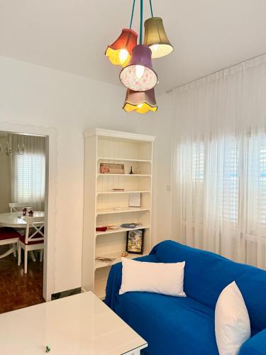 a living room with a blue couch and a table at Green Door 3bdr flat City Centre in Nicosia