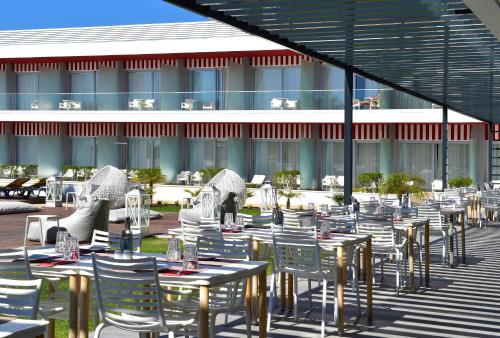 a row of tables and chairs in front of a building at Pestana Alvor South Beach Premium Suite Hotel in Alvor