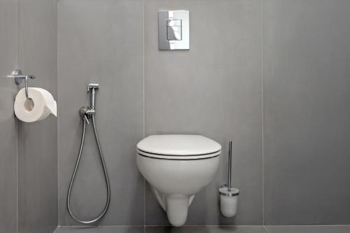 a bathroom with a white toilet and a shower at DilijanInn Hotel and Restaurant in Dilijan