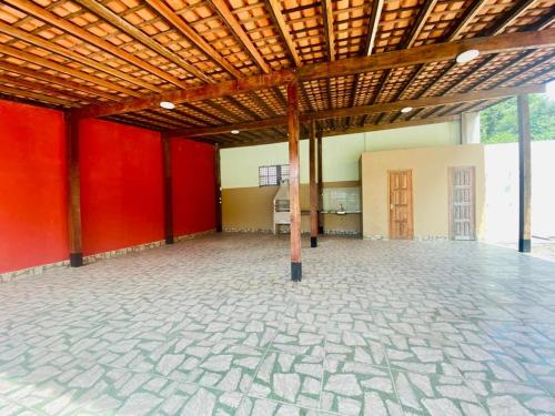a large room with red walls and a wooden ceiling at COP 30 Belém comfy private room in Benevides