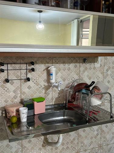 a kitchen sink with a faucet and dishes at COP 30 Belém comfy private room in Benevides