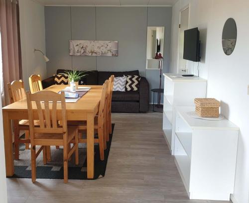 a kitchen and living room with a table and chairs at Eckerö Camping & Stugor in Eckerö