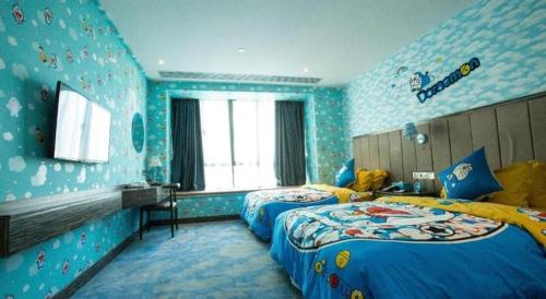 a bedroom with two beds in a blue room at Landmark Hotel in Zhuhai