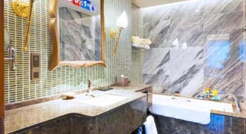 a bathroom with a tub and a sink and a tub at Wuhan Gleetour Hotel in Wuhan