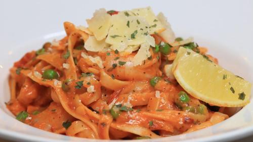 a plate of pasta with a lemon slice on top at Best Western Cattle City Motor Inn in Rockhampton