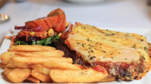 a plate of food with meat and french fries at Best Western Cattle City Motor Inn in Rockhampton