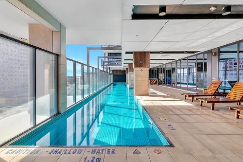 a swimming pool on top of a building at Cityscape Haven - CBD retreat with an array of Hotel Amenities in Adelaide