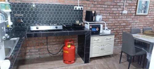 a red fire hydrant sitting in the middle of a kitchen at Raniah homestay in Kuching