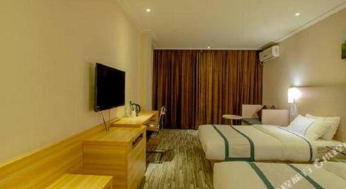 a hotel room with two beds and a flat screen tv at City Comfort Inn Nanning Zoo Keyuan Avenue in Nanning