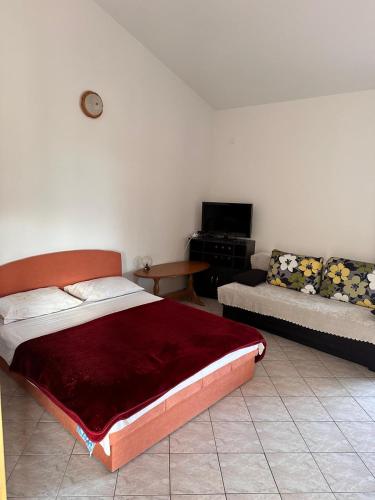 a bedroom with a bed and a couch at Ranka1 Krk in Kornić