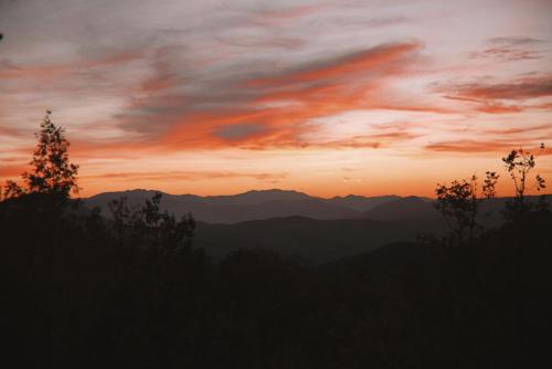 a sunset with mountains in the background at KATIKIA ZAGORI in Vitsa